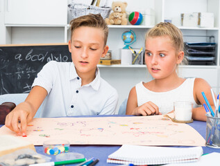 Boy with sister are playing in game at home.