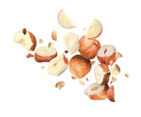 Pieces of tasty hazelnuts falling on white background