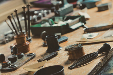Display of a vintage watchmakers workbench with hand tools