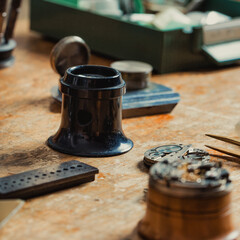 Old vintage Jewellers Loupe on a wooden workbench