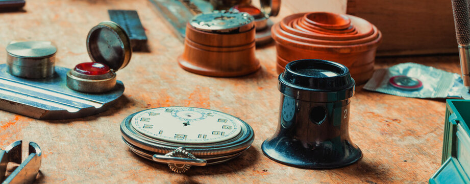 Panorama banner with watchmakers tools and Hunter pocket watch