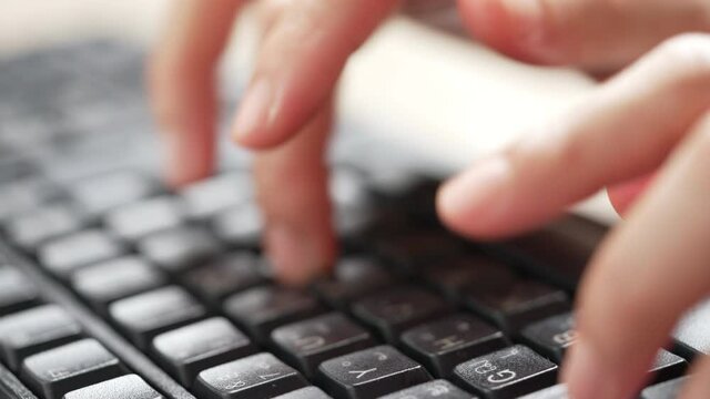 close up hand of a business woman typing keyboard desktop computer on desk office