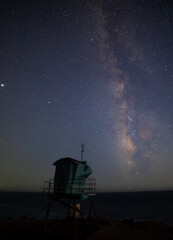 Milky way galaxy over a lifeguard tower in Malibu