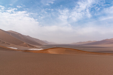 Fototapeta na wymiar Nature and landscapes of dasht e lut or sahara desert with sand dunes and cloudy evening sky