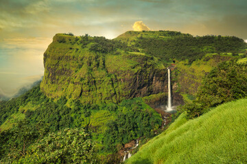 Beautiful waterfall with dramatic sky, somewhere in the Sahyadri ranges of western ghats of Maharashtra.
