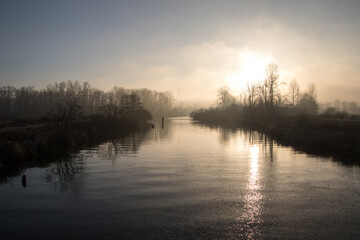 Fototapeta premium A view of a river with bush filled banks