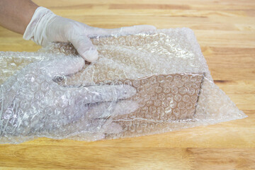 hand of man hold bubble wrap, for protection parcel product cracked or insurance During transit