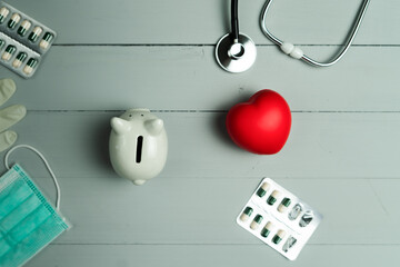 World health day concept and Healthcare medical insurance with red heart and medical instrument on wooden background