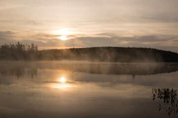 Fototapeta na wymiar Calm lake with mist rising