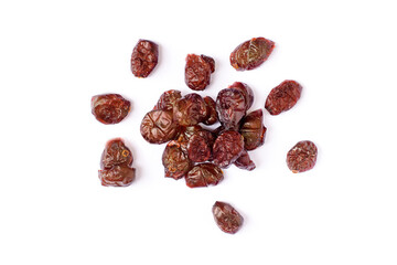 Dried red raisins on white background.