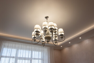 beautiful chandelier with bulges and contours in a large house, modern lamps