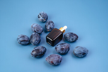 Essence for the health of the skin on the background of plums. Healthy lifestyle. Serum for men and women