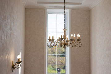 beautiful chandelier with bulges and contours in a large house, modern lamps