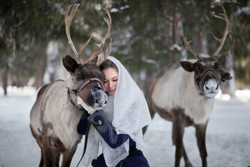 A girl walks in the winter with deer in the forest. Fairy tale. Reindeer. Fabulous photo session © AKaltykova