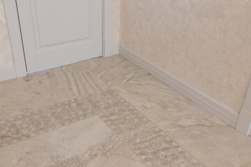 wide and white wooden skirting board in a large house with a modern design