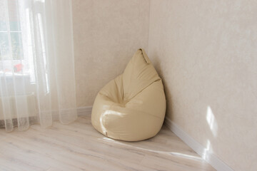 leather armchair bag in the corner of the room in beige
