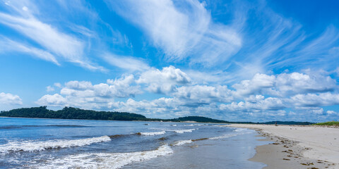 Autumn whimsical clouds and the beach on Plum Island in the Atlantic Ocean. Massachusetts, USA