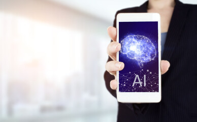 The modern concept of the cyberbrain. Hand hold white smartphone with digital hologram Artificial Brain intelligence sign on light blurred background. Artificial intelligence AI