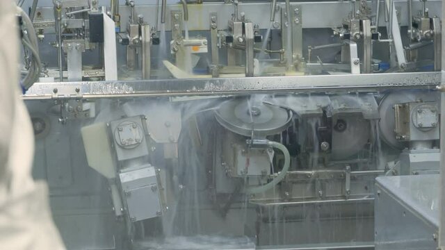 Fish processing plant. A floating base in the open sea. Baader cuts freshly caught fish in two. Making fish fillets.