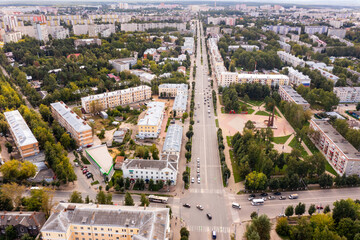 Aerial cityscape of Russian city Kovrov with view of residental buildings and square with Eternal Fire.