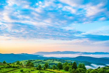 fog in the mountains. sunrise on the mountains in the fog on a beautiful warm day. mountain landscape. natural phenomenon. countryside .