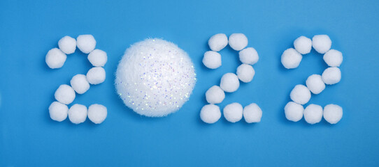 Number 2022 New Year made from snow balls on a blue background Banner