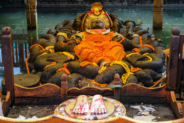 Kathmandu, Nepal - October 2021: Reclining statue of Vishnu as Narayan, the creator of all life in Budhanilkantha on October 5, 2021 in Kathmandu, Nepal.