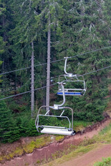 Fototapeta na wymiar Mountain lift cabins and trees