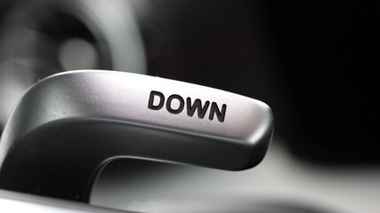 Extreme close-up of a car steering wheel paddle shifter on blurred background