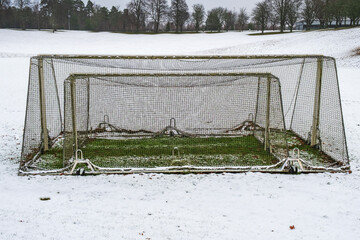 Snow covered football field with goal