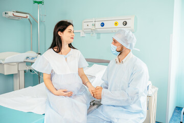 Caring gusband supporting pregnant woman at hospital
