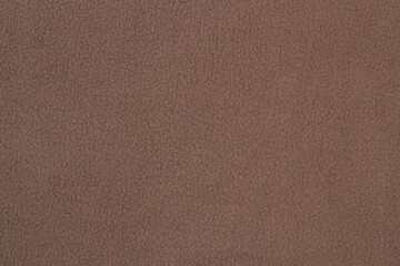 Fleece fabric brown top view. Texture of textile fleece bedspread.	