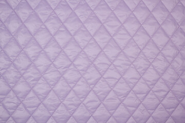 Lilac quilted fabric. The texture of the blanket