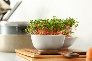 Bowls with organic micro green sprouts on table