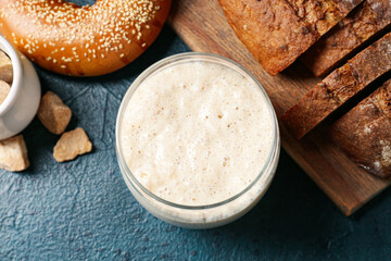 Jar with fresh sourdough on table