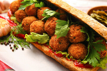 Bread with tasty cod cutlets on table, closeup