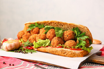 Board with bread and tasty cod cutlets on table
