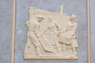 Themed sculptural murals decorating the walls of buildings. Bas-relief on the wall.