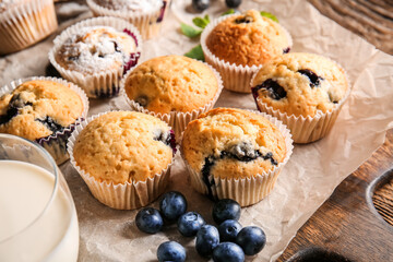 Tasty blueberry muffins on table, closeup