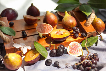 Fruits on the table. Grapes,Fruit platter on the table. Grapes, peaches and figs for breakfast. 
Autumn still life Warm colors. peaches and figs