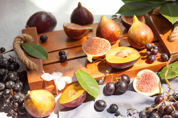 Fruits on the table. Grapes,Fruit platter on the table. Grapes, peaches and figs for breakfast. 
Autumn still life Warm colors. peaches and figs