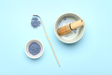 Composition with powdered blue matcha tea on color background