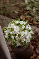 White freesia bridal bouquet on dark background. close up. Wedding bouquet.