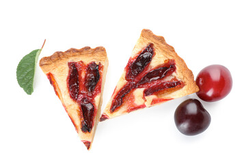 Pieces of tasty plum pie on white background
