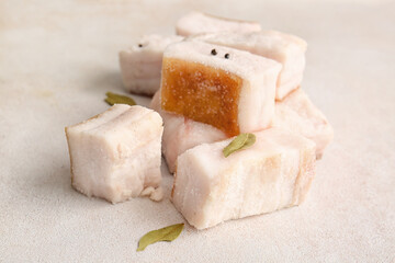 Pieces of salted lard on light background