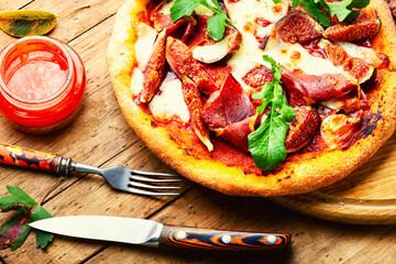 Pizza with meat and fruits