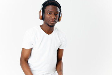 African American with headphones listening to music lifestyle technology light background