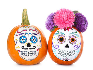 Pumpkins with painted skull on white background. Celebration of Mexico's Day of the Dead (El Dia de Muertos)