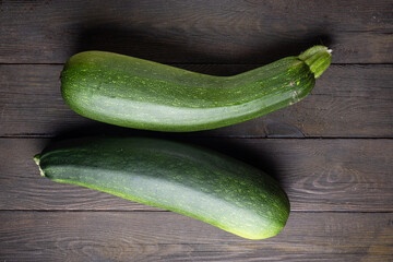 Fresh zucchini, squash on a wood background.