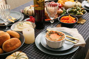 Pumpkin pie and different food on festive served table